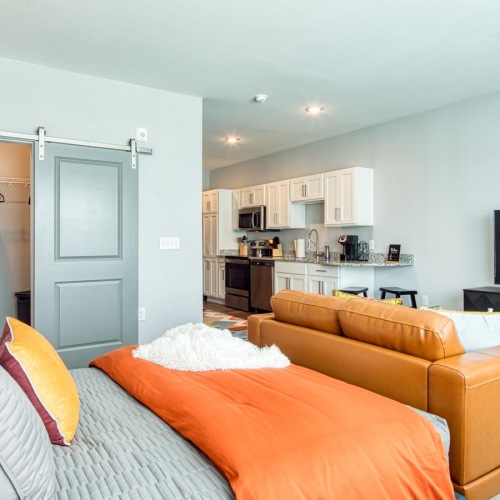 a living room with orange couches