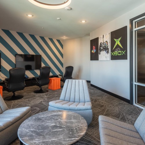 a room with a couch and chairs