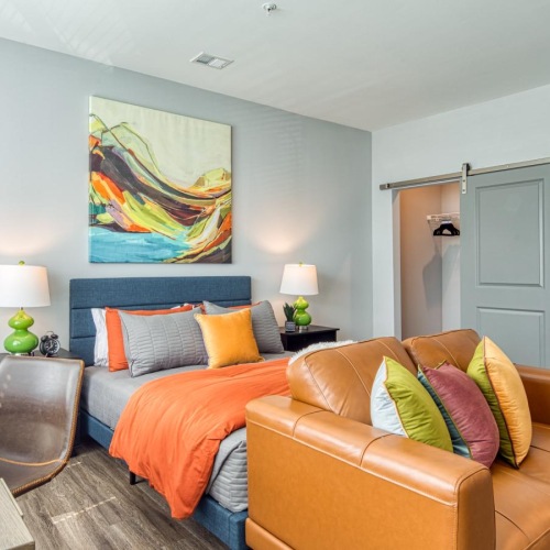 a room with a couch and a table with a lamp on it