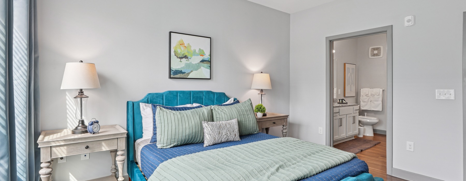 furnished bedroom with side tables and ensuite bathroom